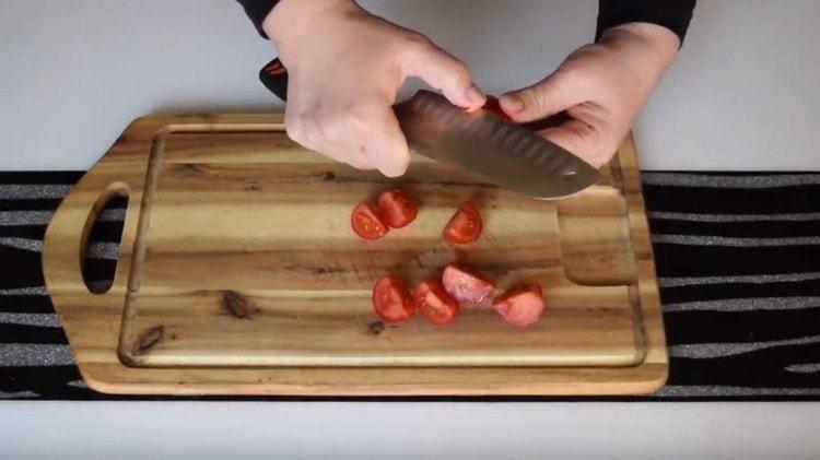 Schneiden Sie die Tomaten in kleine Stücke.