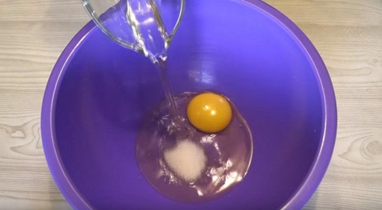 Προσθέστε φυτικό λάδι και αλάτι στο αυγό.